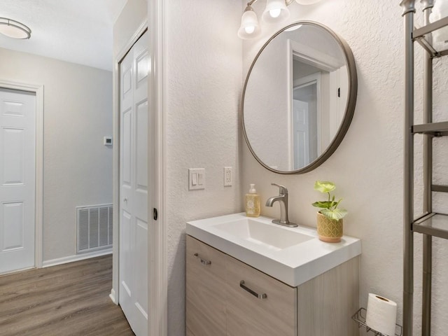 bathroom with vanity and hardwood / wood-style floors