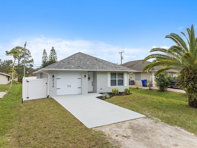 single story home with a garage, central AC, and a front lawn