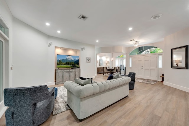 living area with recessed lighting, visible vents, light wood-style flooring, and baseboards