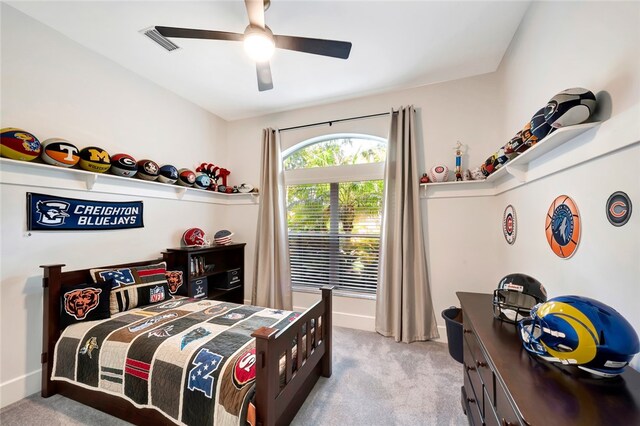 bedroom featuring ceiling fan, baseboards, visible vents, and light colored carpet