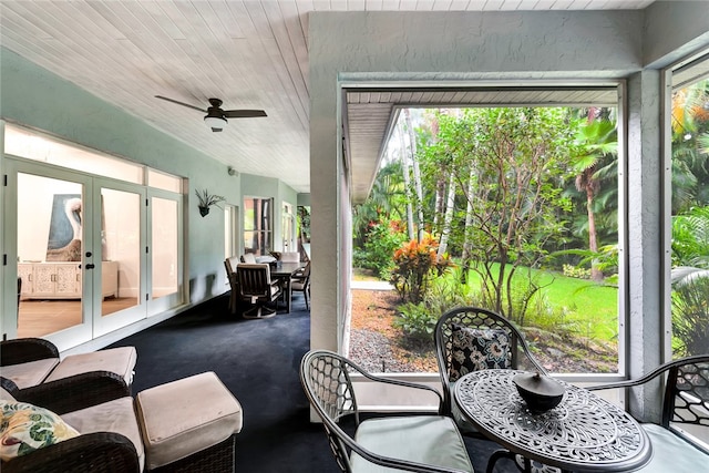 sunroom / solarium with ceiling fan, french doors, and wood ceiling