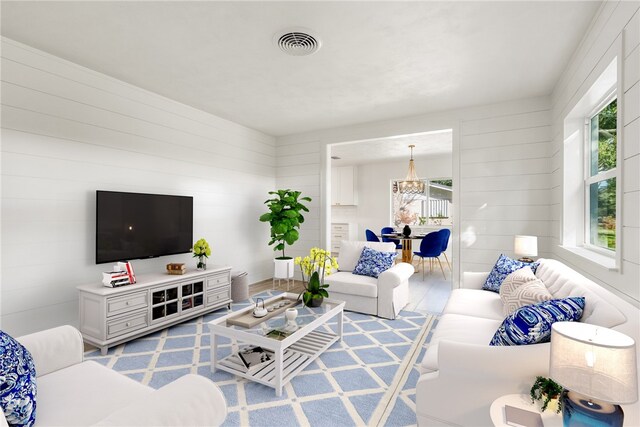 living room with a wealth of natural light and an inviting chandelier