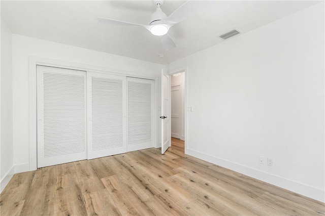 unfurnished bedroom with a closet, light wood-type flooring, and ceiling fan