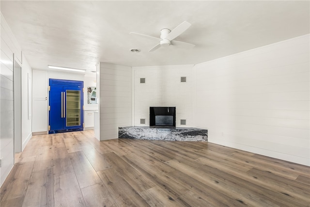 unfurnished living room featuring hardwood / wood-style floors and ceiling fan