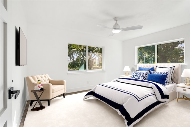 bedroom with ceiling fan and light hardwood / wood-style flooring