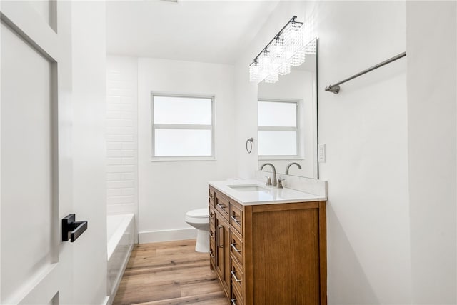 full bathroom with shower / washtub combination, hardwood / wood-style floors, vanity, and toilet