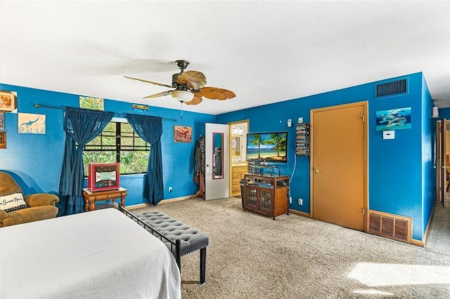 carpeted bedroom with a textured ceiling, ceiling fan, visible vents, and baseboards