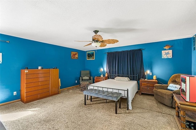 carpeted bedroom with ceiling fan, baseboards, and a textured ceiling