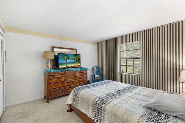 bedroom with light carpet and baseboards