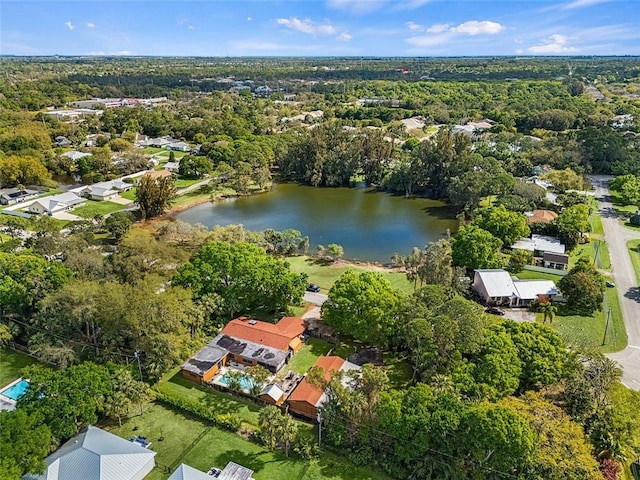 drone / aerial view featuring a water view and a wooded view