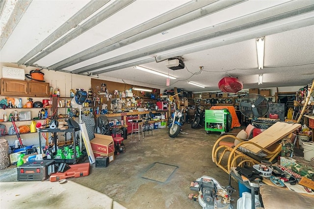 garage featuring a garage door opener and a workshop area