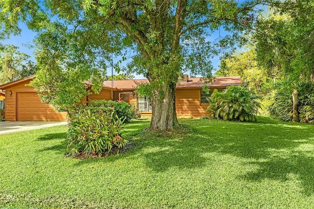 view of front of property featuring a garage and a front lawn