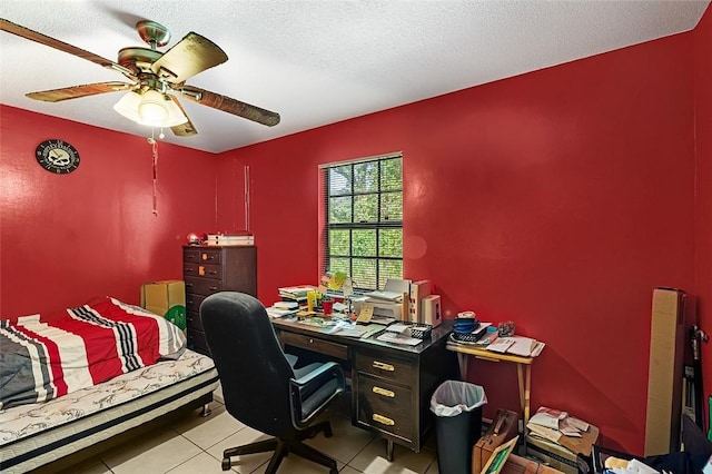 tiled office space with ceiling fan and a textured ceiling