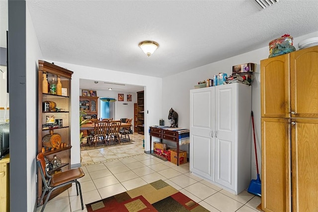 kitchen featuring visible vents, a textured ceiling, and light tile patterned floors