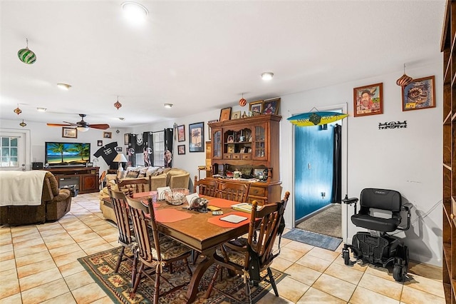 dining area featuring light tile patterned floors and a ceiling fan