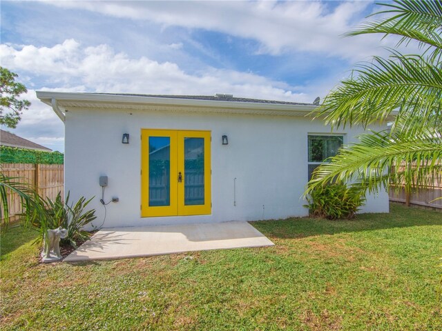 back of house with french doors, a yard, and a patio area