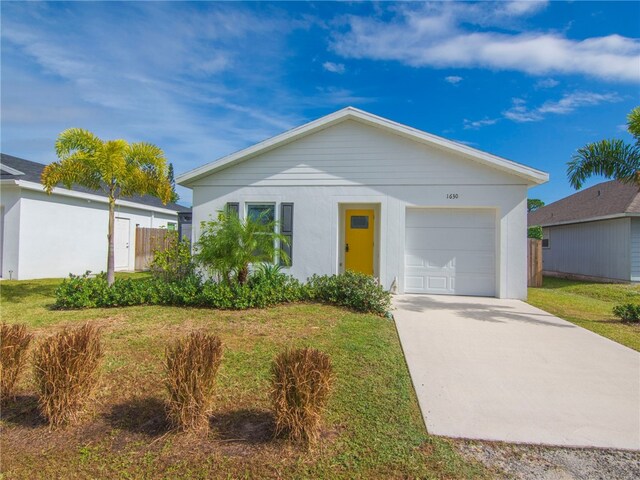 single story home featuring a front yard and a garage