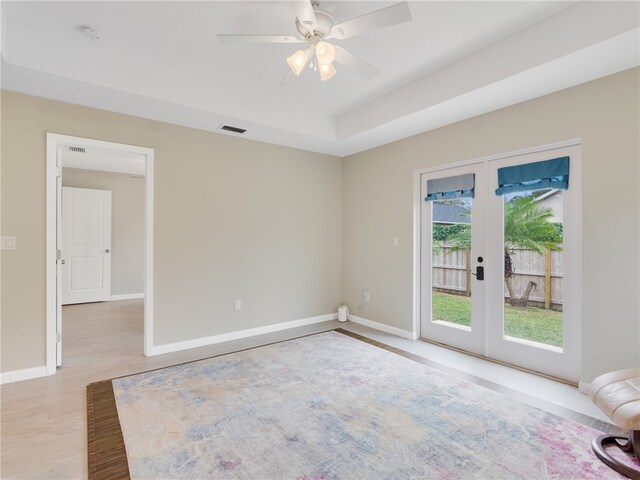 empty room with french doors, light hardwood / wood-style flooring, and ceiling fan