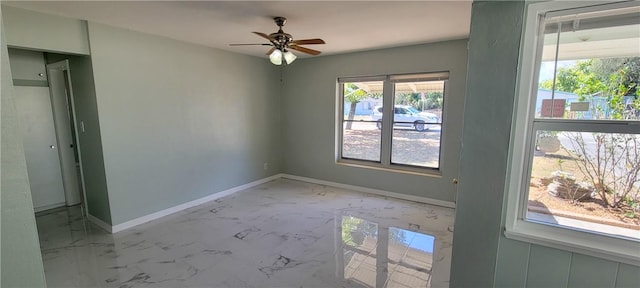 unfurnished room featuring ceiling fan and a healthy amount of sunlight