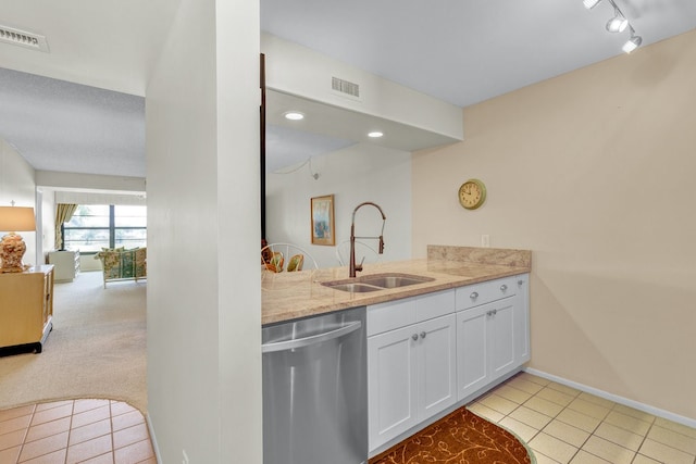 kitchen featuring dishwasher, light carpet, sink, light stone counters, and white cabinetry