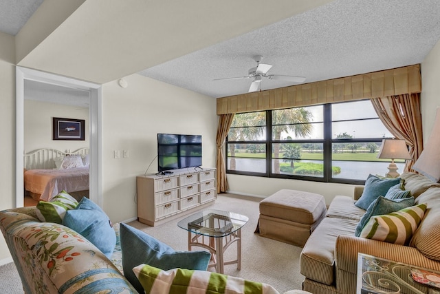 carpeted living room with a textured ceiling and ceiling fan