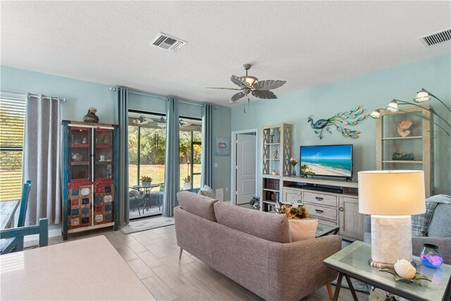 10095 W Villa Cir, Vero Beach, FL 32966 - living area with a ceiling fan, visible vents, and a healthy amount of sunlight