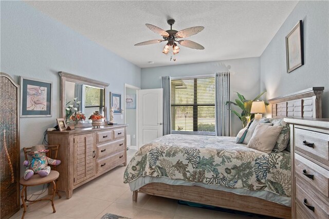 10095 W Villa Cir, Vero Beach, FL 32966 - bedroom with a textured ceiling, a ceiling fan, and light tile patterned flooring