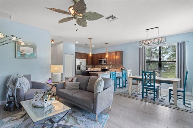 10095 W Villa Cir, Vero Beach, FL 32966 - living room with baseboards, light wood finished floors, and visible vents
