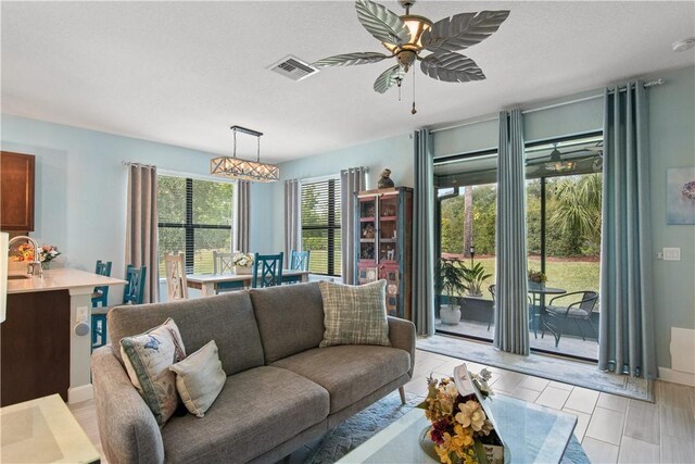 10095 W Villa Cir, Vero Beach, FL 32966 - living room with baseboards, a ceiling fan, and visible vents