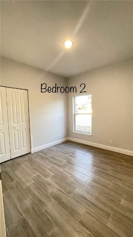 spare room featuring hardwood / wood-style floors and a textured ceiling