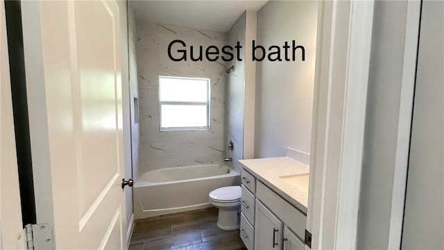 full bathroom featuring vanity, hardwood / wood-style flooring, toilet, and tiled shower / bath