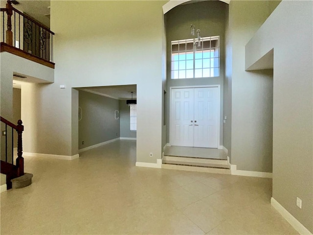 foyer featuring a towering ceiling