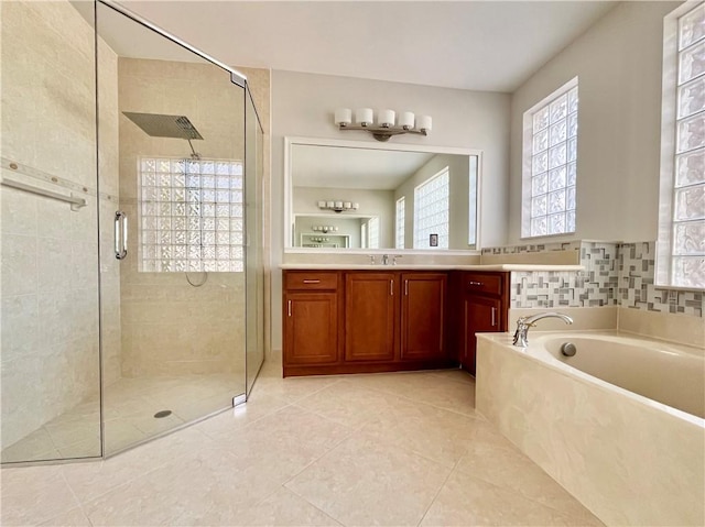 bathroom with tile patterned flooring, vanity, and separate shower and tub