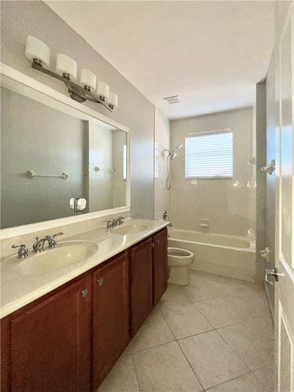 full bathroom with tile patterned flooring, vanity, toilet, and tiled shower / bath