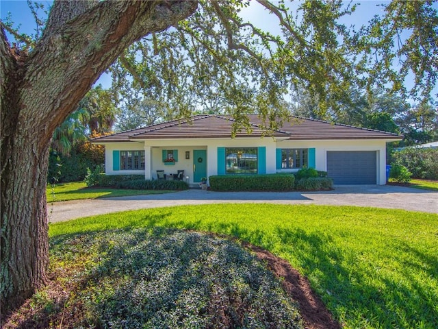 single story home featuring a front yard and a garage