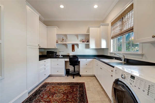 kitchen featuring sink, white cabinetry, ornamental molding, and independent washer and dryer