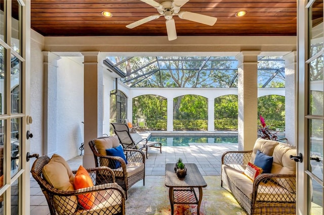 view of patio / terrace with a lanai, ceiling fan, and an outdoor living space