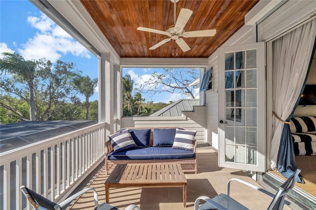 sunroom with ceiling fan and wood ceiling