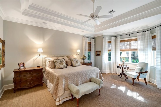 carpeted bedroom with ornamental molding, a raised ceiling, and ceiling fan