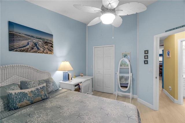 223 River Walk Unit 12, Hutchinson Island, FL 34949 - bedroom with light wood-type flooring, a towering ceiling, a closet, and a ceiling fan