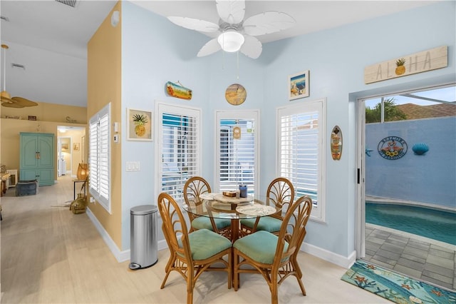 223 River Walk Unit 12, Hutchinson Island, FL 34949 - dining room featuring ceiling fan, high vaulted ceiling, and healthy amount of natural light