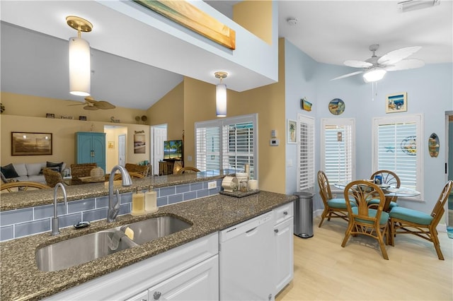 223 River Walk Unit 12, Hutchinson Island, FL 34949 - kitchen with a ceiling fan, white dishwasher, high vaulted ceiling, dark stone counters, and white cabinetry