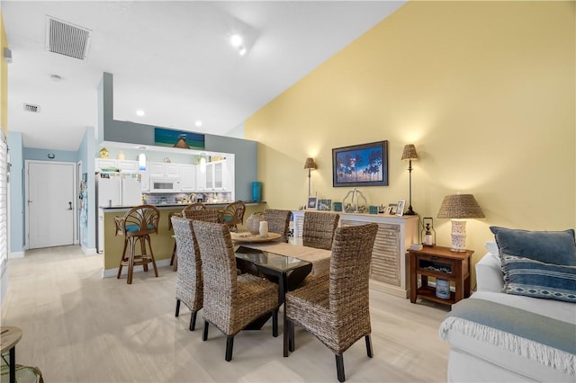 223 River Walk Unit 12, Hutchinson Island, FL 34949 - dining area with high vaulted ceiling and baseboards