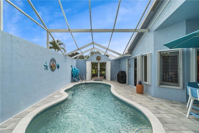 223 River Walk Unit 12, Hutchinson Island, FL 34949 - swimming pool featuring a patio, glass enclosure, and french doors