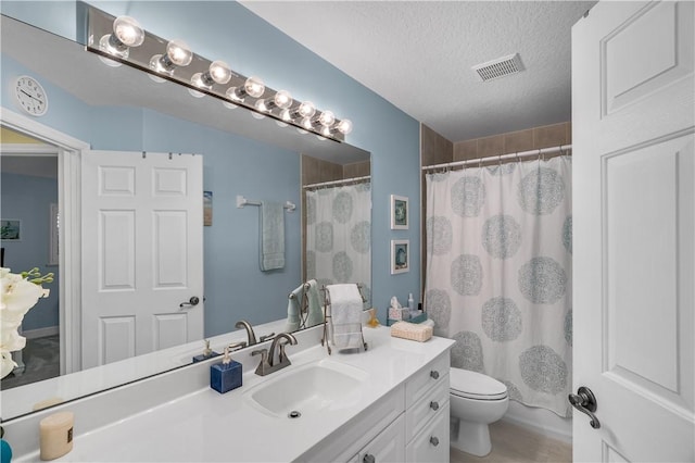 223 River Walk Unit 12, Hutchinson Island, FL 34949 - full bathroom featuring vanity, a textured ceiling, and a shower with curtain