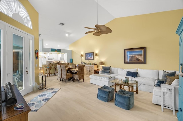 223 River Walk Unit 12, Hutchinson Island, FL 34949 - living room featuring ceiling fan, high vaulted ceiling, and light wood-style floors
