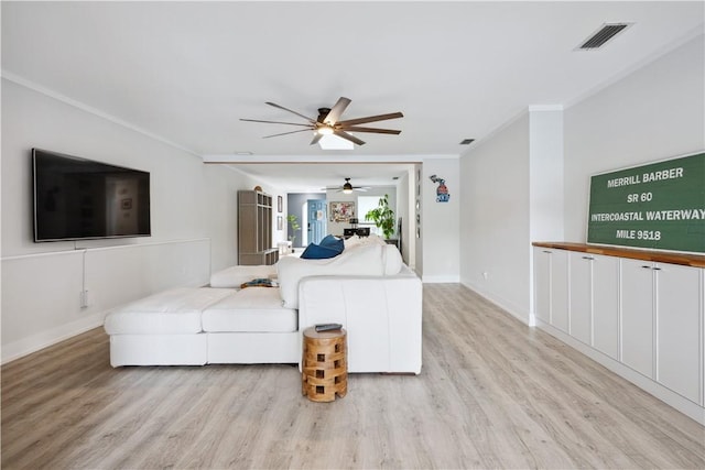 1933 Robalo Dr, Vero Beach, FL 32960 - living room featuring light wood-style flooring, a ceiling fan, and crown molding