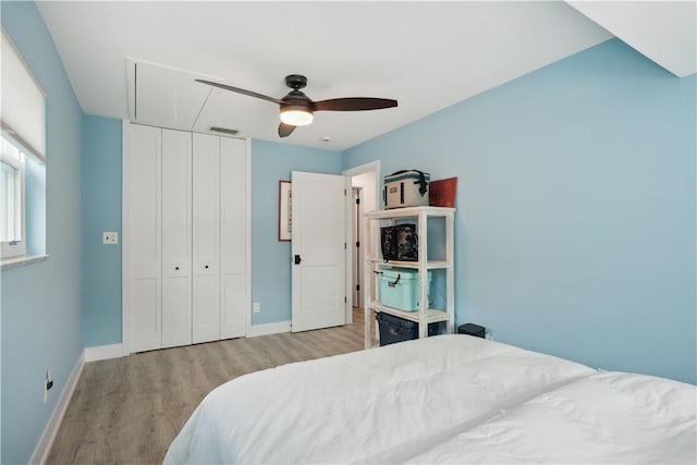1933 Robalo Dr, Vero Beach, FL 32960 - bedroom with wood finished floors, attic access, a closet, and ceiling fan