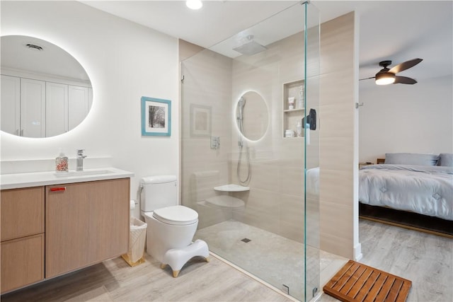 1933 Robalo Dr, Vero Beach, FL 32960 - bathroom featuring wood finished floors, vanity, a shower stall, and a ceiling fan