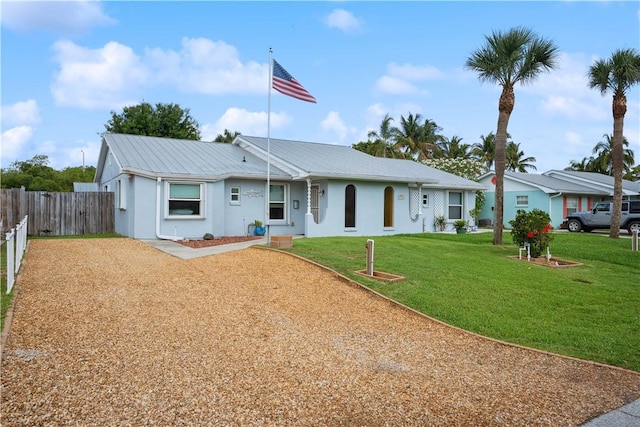 1933 Robalo Dr, Vero Beach, FL 32960 - view of front of property with stucco siding, a metal roof, and driveway